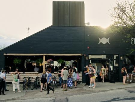 Brewery with locals gathering outside, enjoying the summer sun