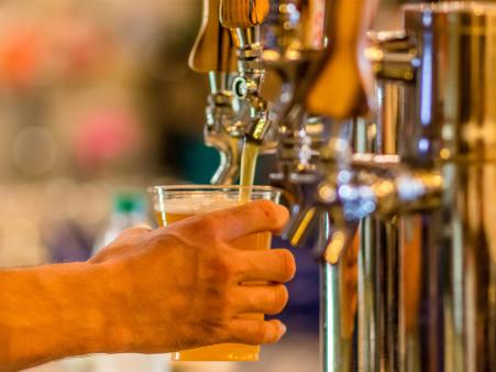 Beer taps pouring at Deep River Brewery in Clayton, NC.