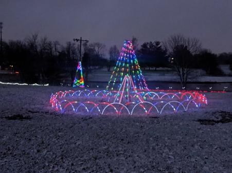 a coating of snow on the ground with christmas lights twinkling at boone county light up the fair in northern kentucky