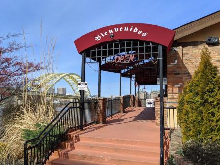 exterior photo of cancun mexican restaurant and bar with photo of big mac bridge in background over the ohio river in newport ky and cincinnati oh