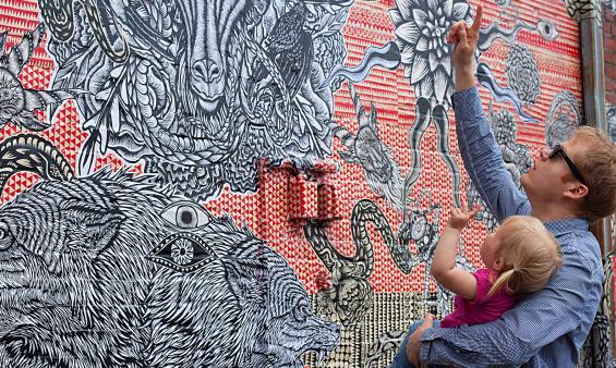 Man Holding Child Looking At A Mural In Richmond, VA