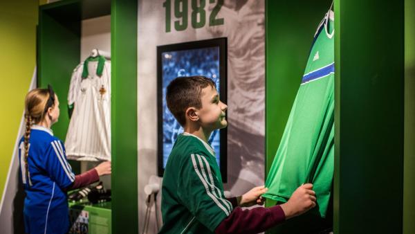Boy looking at football jersey at Irish FA