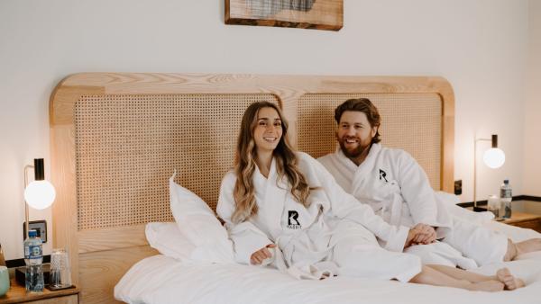 Couple laying on bed at The Rabbit