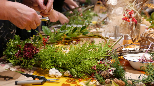 A woman making a Christmas wreath