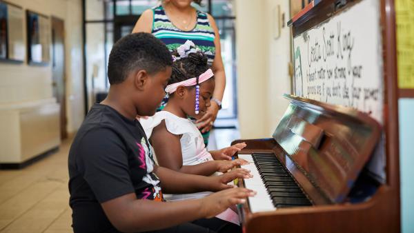 Kids playing the piano at the King Arts Complex