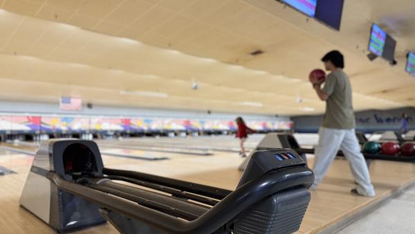 A man takes a step back and readies a ball to be bowled at Bowling World in Fort Smith, Arkansas.