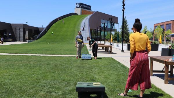 Playing bean bag toss at Titletown park