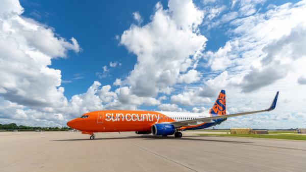 Sun Country Airlines aircraft parked on a runway at an airport