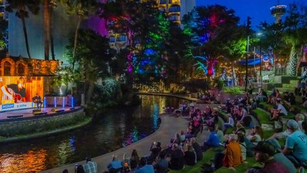 People on lawn enjoying concert