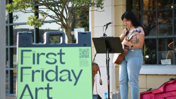 Person plays live music in downtown Vancouver at the recurring First Friday event