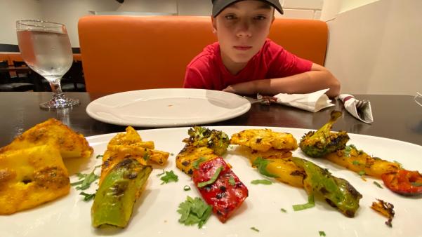 A boy eating dinner at a restaurant