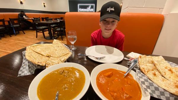 A boy eating dinner at a restaurant