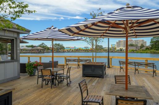 Cafe seating at Barefoot Landing over looking a lake.