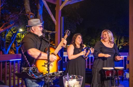 Live musicians performing at an outdoor restaurant patio.