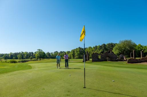 two golfers on the green on a beautiful sunny day