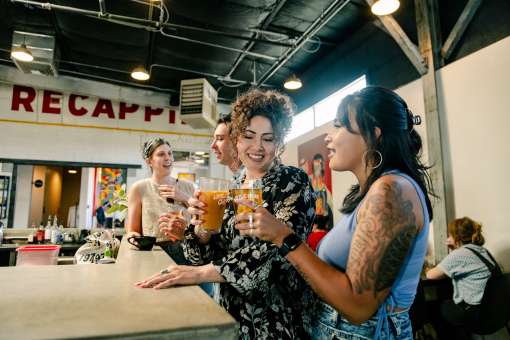Two women chat at the counter of Little Bear Nob Hill