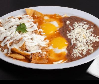 Plate of chilaquiles, eggs, and refried beans