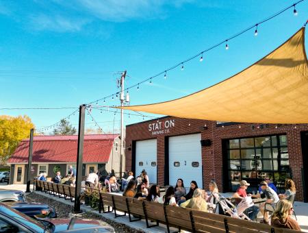 Customers sitting on the patio and enjoying the weather at Station 1 Brewing in Green Bay, Wisconsin.