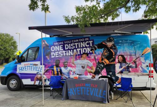 DistiNCtly Fayetteville MIC van and event booth set up outside the Airborne & Special Operations Museum, promoting local attractions and community engagement.