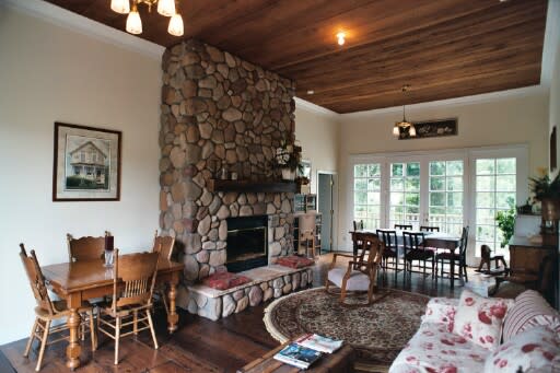 Living room with stone fireplace at Pescadero Creek Inn