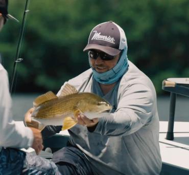 Capt. Jay Withers holding a redfish
