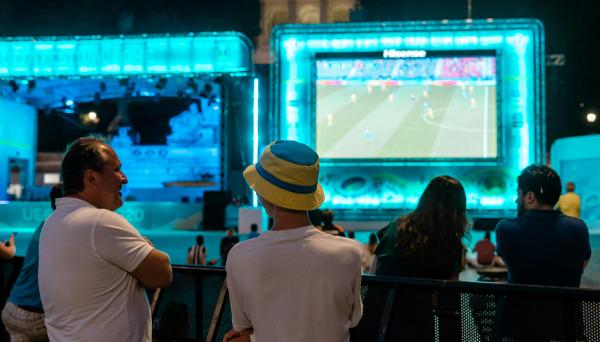 People watching a soccer game at viewing party