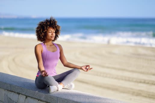 Woman meditating at beach