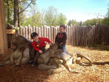 Two boys on lion statue at the Seneca Park Zoo