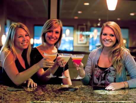 Amber Lantern - 3 Women at Bar with Martinis Toasting