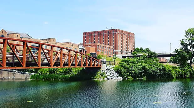 A bridge and the National Comedy Center seen from the Jamestown Riverwalk