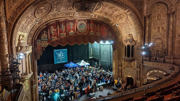 People gather on the stage at the Landmark Theatre for the New York State Craft Brewers Festival