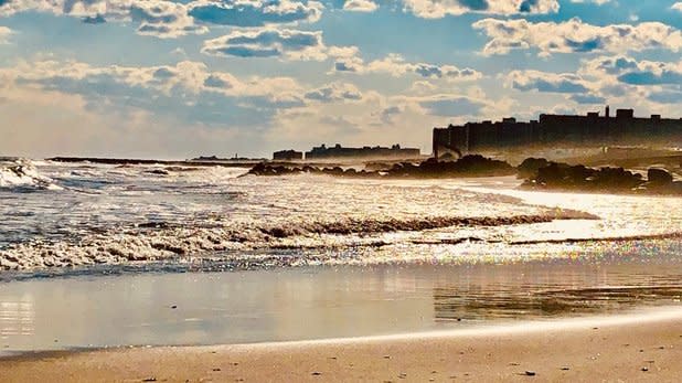 Waves crashing onto the sandy shores of Rockaway Beach