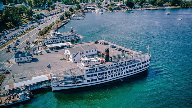A Lake George Steamboat Company vessel docked on the water in Lake George