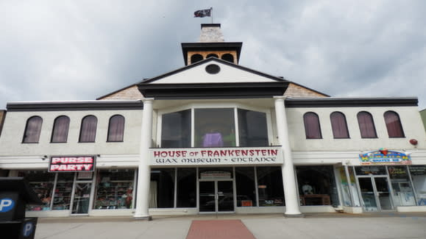 exterior of a white museum building that reads "House of Frankenstein" in red text on Lake George's main street
