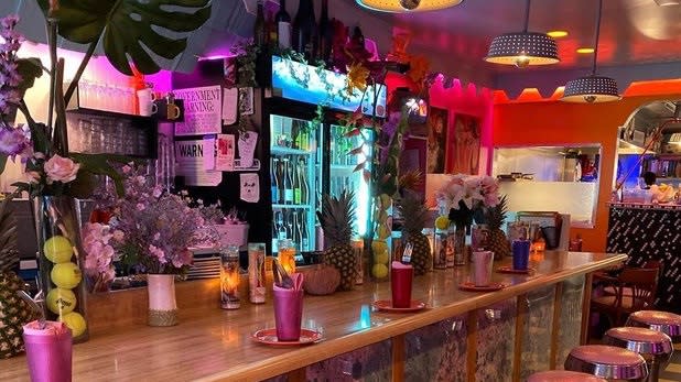 Vibrant, bright, and pink interior of the bar at Lil Deb's Oasis