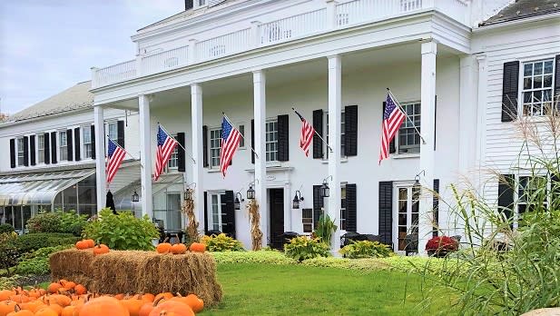 Pumpkins and hay bales dot the green lawn outside the historic Beekman Arms & Delamater Inn
