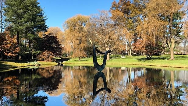 A bronze sculpture appears to float above a pond at the Donald Kendall Sculpture Garden on the grounds of the PepsiCo headquarters