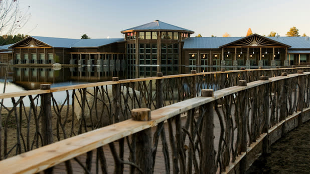 A bridge over top water in front of the Wild Center
