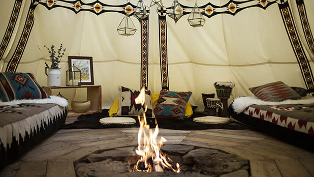A roaring fireplace inside a glamping tent at Bellfire in the Catskills