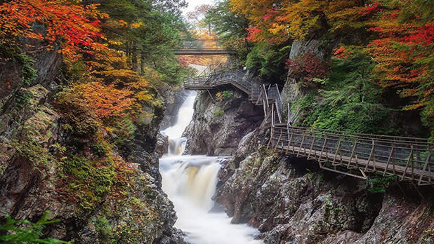 Waterfall and surrounding fall foliage at High Falls Gorge