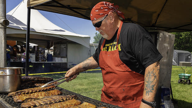 A man grilling at the Grand Am BBQ Championship