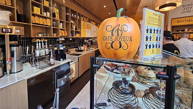 A welcoming bakery scene showcasing a pumpkin placed on the counter, enhancing the autumnal ambiance of the space.