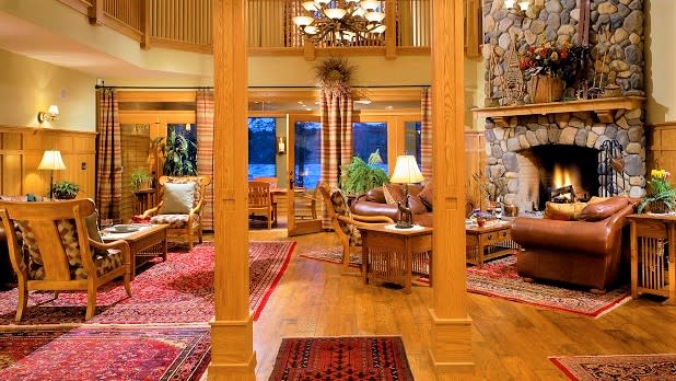 Cozy sitting room with a stone fireplace at the Fern Lodge