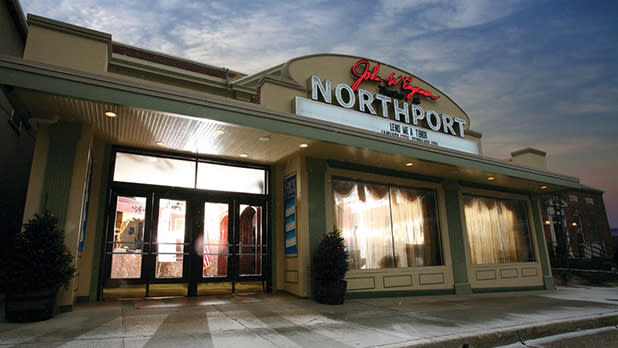 A one story building with lit up windows with a sign at the top reading John W. Engeman Theater at Northport