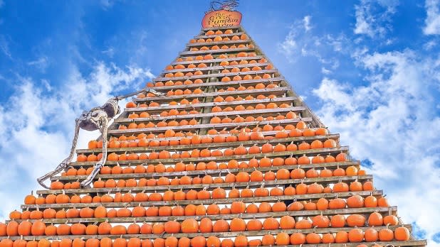 A towering pyramid of bright orange pumpkins at the Great Pumpkin Farm
