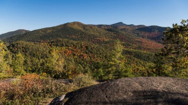 View of the surrounding Adirondack Mountains with fall colors from Baxter Mountain