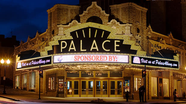 The exterior of the Palace Theater lit up at night