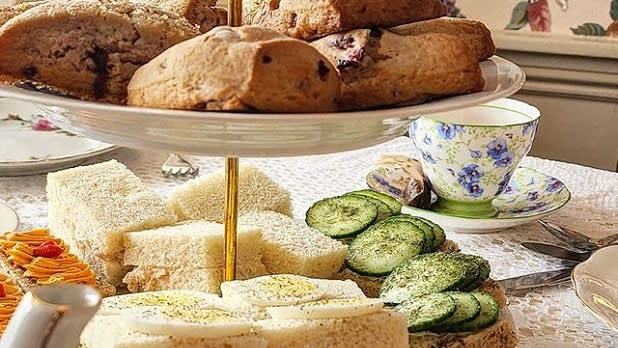Three-tiered stand with scones and finger sandwiches