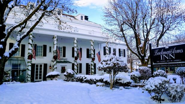 Exterior of the Beekman Arms and Delamater Inn covered in snow and decorated for the holidays