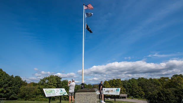 Two people admire the view and plaques at Bennington Battlefield State Historic Site